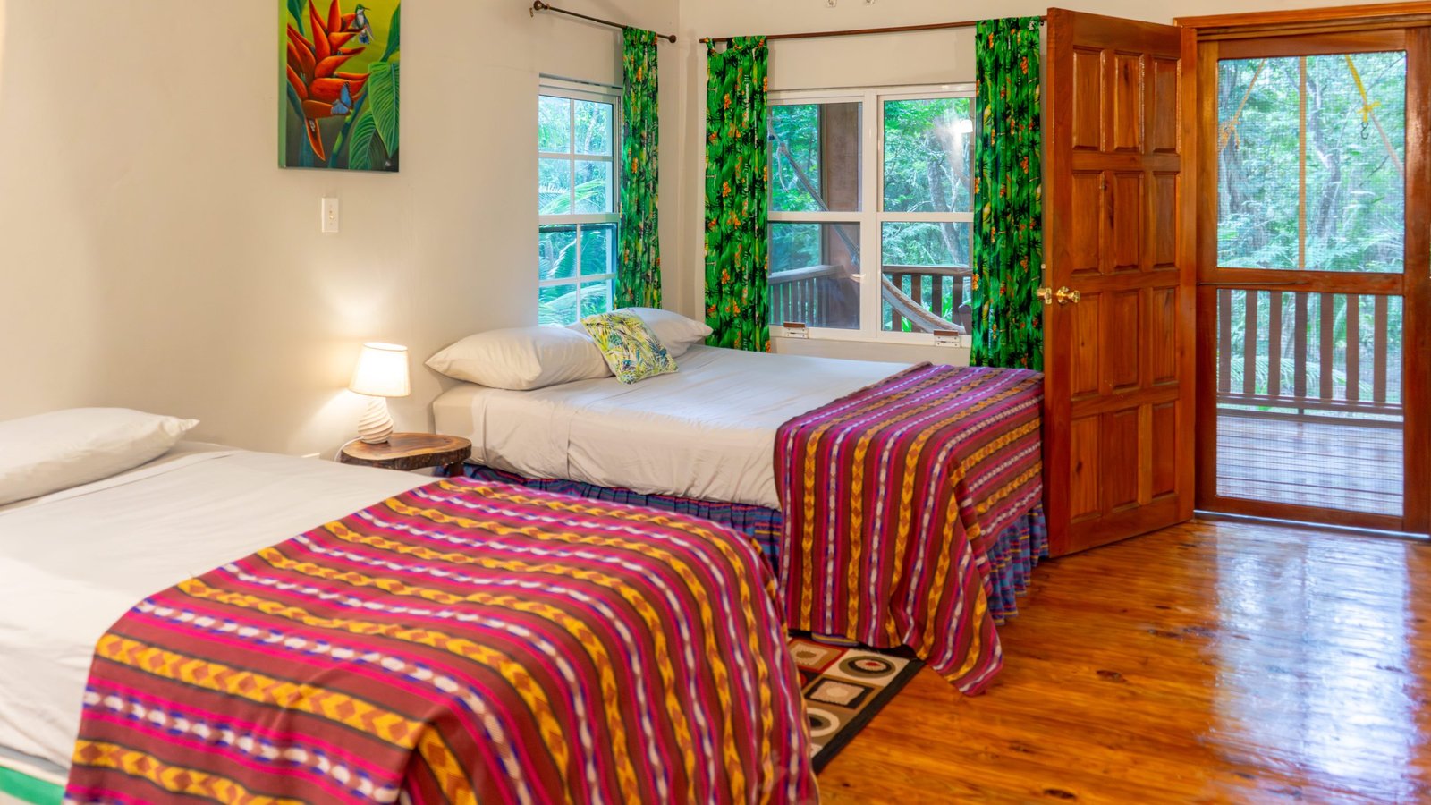 Family Toucan Cottage bedroom with two beds at The Cabins at Monkey Falls