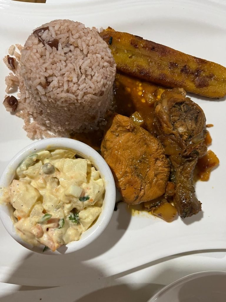 Belizean meal with rice, salad, and fried plantains